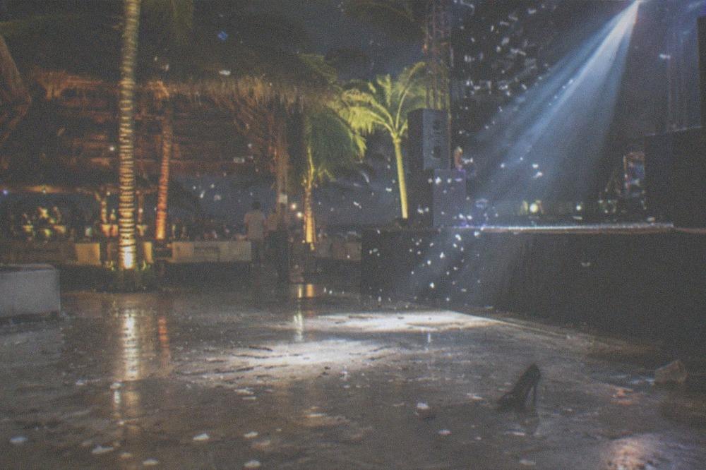 Falling confetti and bright stage lights over an empty dance floor