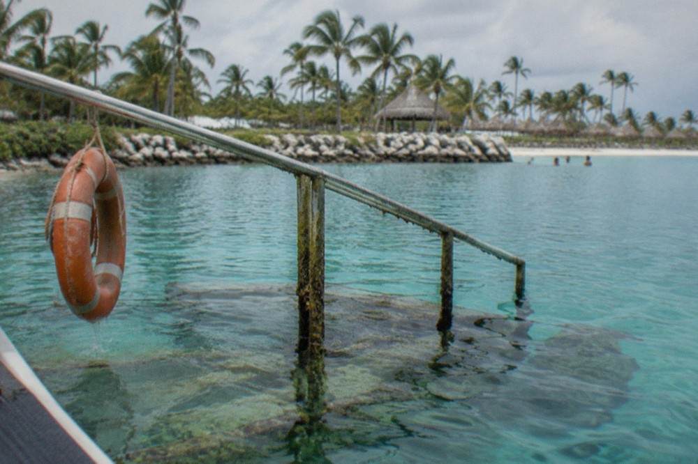 Clear turquoise lagoon water with a submerged platform at a marine park