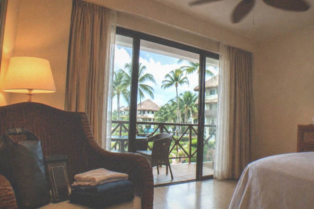 Small dry bag with a phone pouch and folded clothes sitting on a hotel room chair